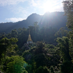 Another view of Wat Tham Pha Plong temple with more sun peeking over the mountain